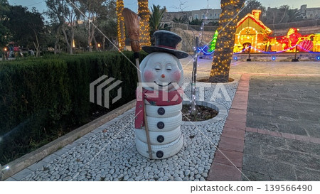 Christmas decoration statue of a smiling snowman in a park 139566490