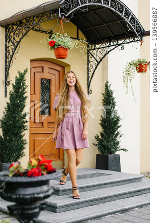 Elegant Woman Walking Down Steps In Pink Dress Elegant Woman Walking Down Steps In Pink Dress 139566887