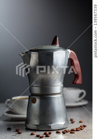 An authentic vintage Italian coffee maker with a retro design and aged metal texture. 139567339