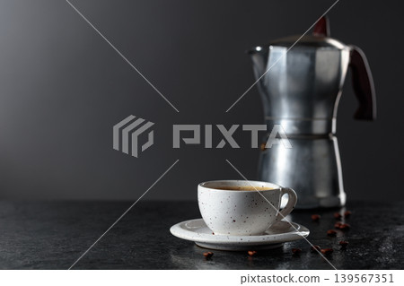 Cup of espresso and classic Italian aluminium moka pot on a stone table. Cup of espresso and classic Italian aluminium moka pot on a stone table. 139567351