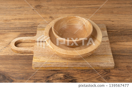 Empty wood bowl on table, plate stack on wooden table, light rustic dish mockup, eco bio Empty wood bowl on table, plate stack on wooden table, light rustic dish mockup, eco bio 139567477