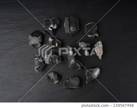 Natural black flint, chert mineral on slate plate Natural black flint, chert mineral on slate plate 139567498