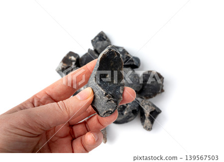 Natural black flint, chert mineral isolated Natural black flint, chert mineral isolated 139567503