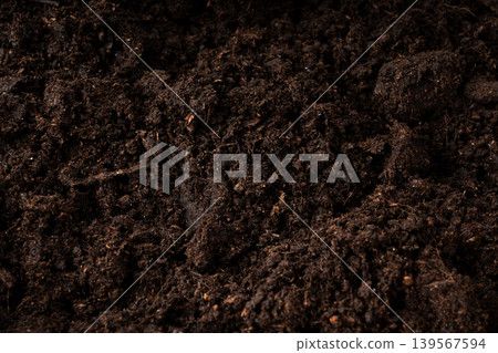 Peat soil textured background. Compost pile, brown garden dirt mound Peat soil textured background. Compost pile, brown garden dirt mound 139567594