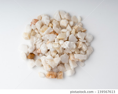 Crushed quartzite pebble pile isolated, white decorative marble stones Crushed quartzite pebble pile isolated, white decorative marble stones 139567613