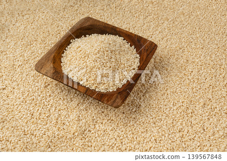 Sesame seeds pile closeup, white small benne grains. Sesamum indicum fruits Sesame seeds pile closeup, white small benne grains. Sesamum indicum fruits 139567848