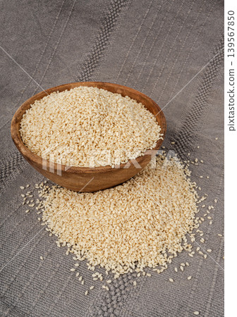 Sesame seeds pile closeup, white small benne grains. Sesamum indicum fruits Sesame seeds pile closeup, white small benne grains. Sesamum indicum fruits 139567850