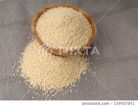 Sesame seeds pile closeup, white small benne grains. Sesamum indicum fruits Sesame seeds pile closeup, white small benne grains. Sesamum indicum fruits 139567851