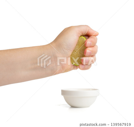 Squeezed lime isolated, squeezed out half green lemon on white background, burnout symbol 139567919