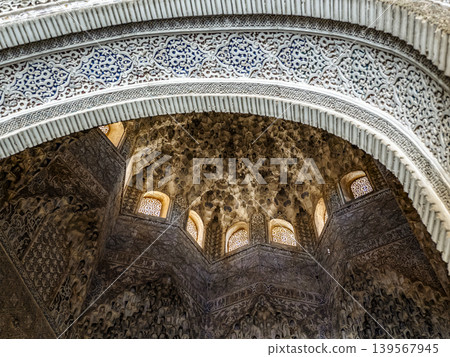 Alhambra Islamic Architecture Interior With Intricate Muqarnas Dome, Carved Stucco Arch and Windows Alhambra Islamic Architecture Interior With Intricate Muqarnas Dome, Carved Stucco Arch and Windows 139567945