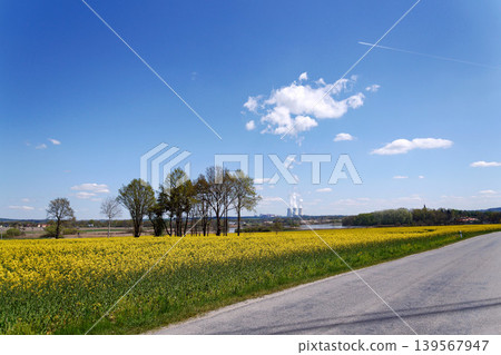 Cooling towers with steam on sky at nuclear power plant with pond and trees nature foreground, Temelin, Czech Republic, energy self-sufficiency, greenhouse emission reduction, global warming concept 139567947