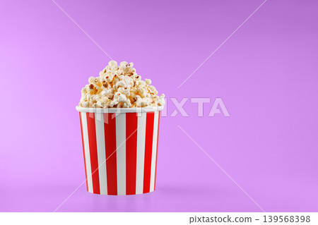 Classic red striped popcorn cardboard cup on Pink background Classic red striped popcorn cardboard cup on Pink background 139568398