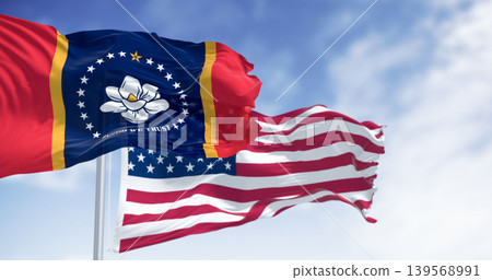 Mississippi state flag waving with the American flag on a clear day Mississippi state flag waving with the American flag on a clear day 139568991