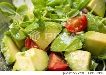 A close-up of a colorful, fresh salad made with avocado and tomato. A close-up of a colorful, fresh salad made with avocado and tomato. 139568996