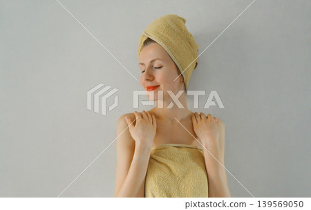 Beauty portrait of happy young caucasian woman touches her clean skin 139569050