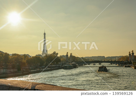Eiffel Tower and Pont Alexandre III over Seine River at sunset, boats cruising through historic Paris Eiffel Tower and Pont Alexandre III over Seine River at sunset, boats cruising through historic Paris 139569126