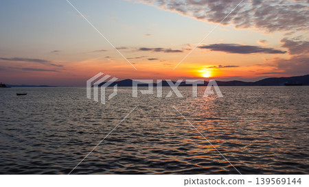 Sunset over tranquil Aegean Sea in Gulluk, Milas, Turkey, golden sun reflecting on the calm water Sunset over tranquil Aegean Sea in Gulluk, Milas, Turkey, golden sun reflecting on the calm water 139569144