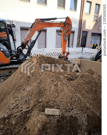 Construction work on a city street with an excavator Construction work on a city street with an excavator 139569268