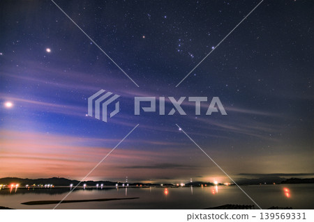 Summer starry sky over the Seto Inland Sea: Orion rising in the dawn sky. Summer starry sky over the Seto Inland Sea: Orion rising in the dawn sky. 139569331