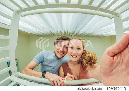Mother and father leaning over baby crib and looking at their newborn from infant point of view. Loving parents, family bonding, childcare and emotional connection concept at home Mother and father leaning over baby crib and looking at their newborn from infant point of view. Loving parents, family bonding, childcare and emotional connection concept at home 139569443