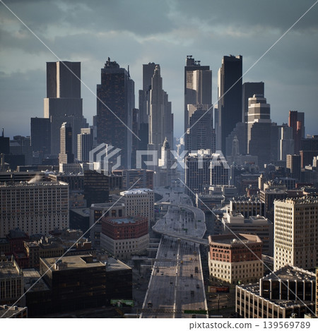Modern skyscrapers dominate the skyline in a vibrant city. Tall buildings reflect sunlight while below, streets are busy with cars and people walking. A moody sky adds drama to the scene. Modern skyscrapers dominate the skyline in a vibrant city. Tall buildings reflect sunlight while below, streets are busy with cars and people walking. A moody sky adds drama to the scene. 139569789