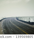 Curved elevated roadway with clear horizon and distant arches, crisp lines and open sky create optimistic minimalist vibe, ideal for infrastructure, mobility, 139569805