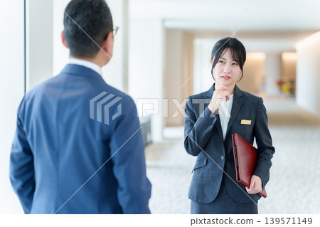 Female staff member suffering from customer harassment Female staff member suffering from customer harassment 139571149