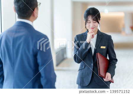 Female staff member suffering from customer harassment Female staff member suffering from customer harassment 139571152