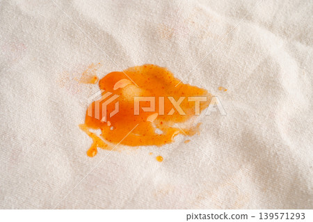 Dirty tomato sauce stain or ketchup on cloth. 139571293