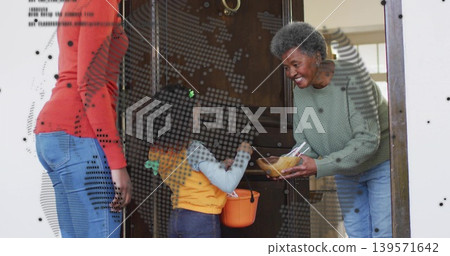 Holding wooden bowl senior in green sweater leaning at doorway, child holding orange pumpkin bucket Holding wooden bowl senior in green sweater leaning at doorway, child holding orange pumpkin bucket 139571642