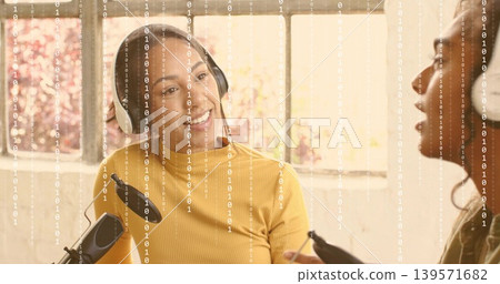 Speaking host wearing mustard top and headphones at home studio with condenser mic, binary overlay Speaking host wearing mustard top and headphones at home studio with condenser mic, binary overlay 139571682
