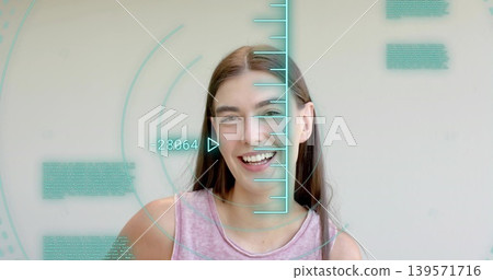 Smiling woman in pink sleeveless top facing camera in studio showing turquoise HUD -28064 overlay Smiling woman in pink sleeveless top facing camera in studio showing turquoise HUD -28064 overlay 139571716