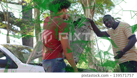 Men holding hood checking engine bay beside white sedan under trees wearing polo green overlay Men holding hood checking engine bay beside white sedan under trees wearing polo green overlay 139571757