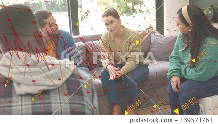 Discussing four people sitting on sofa at home, wearing beige cardigan, showing red overlays Discussing four people sitting on sofa at home, wearing beige cardigan, showing red overlays 139571761