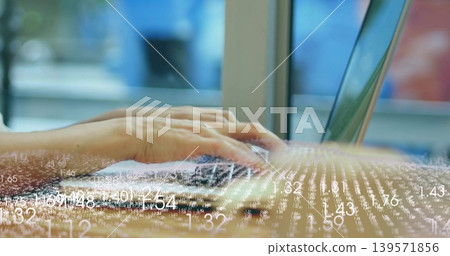 Typing adult hands pressing keys on laptop at desk beside large window, showing data overlay Typing adult hands pressing keys on laptop at desk beside large window, showing data overlay 139571856