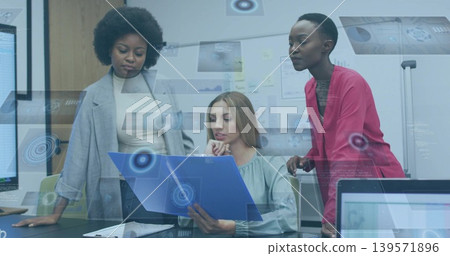 Reviewing three women in grey and red blazers with green blouse at office holding blue-folder 139571896