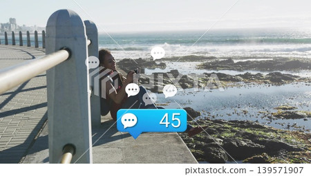 Leaning woman using DSLR on seawall walkway with backpack and chat badge 45, copy space Leaning woman using DSLR on seawall walkway with backpack and chat badge 45, copy space 139571907