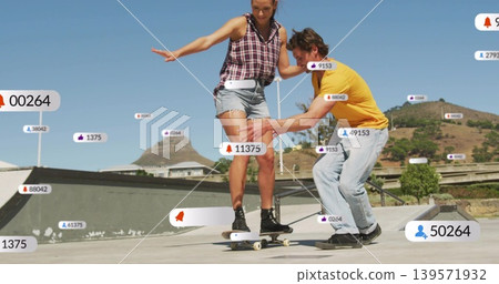 Helping woman balancing on skateboard at skatepark, plaid top and shorts, notification badges Helping woman balancing on skateboard at skatepark, plaid top and shorts, notification badges 139571932