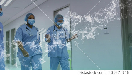Walking three nurses wearing blue scrubs, masks and stethoscopes down hospital corridor, AR overlay Walking three nurses wearing blue scrubs, masks and stethoscopes down hospital corridor, AR overlay 139571946