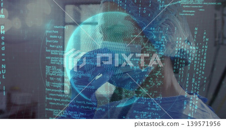 Bowing head, clinician wearing surgical cap, goggles, mask, blue gown in hospital with code overlay Bowing head, clinician wearing surgical cap, goggles, mask, blue gown in hospital with code overlay 139571956