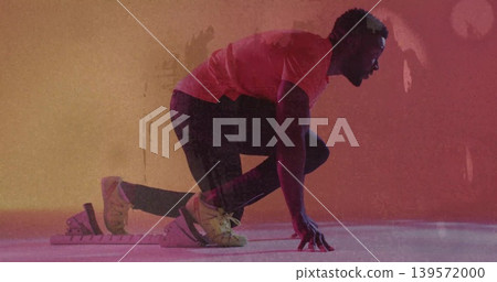 Poising athlete in leggings crouching in studio with block and strapped shoes, magenta orange light Poising athlete in leggings crouching in studio with block and strapped shoes, magenta orange light 139572000