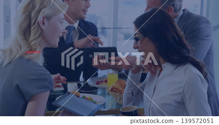 Discussing colleagues in suits and blouses holding tablets and gesturing with pastries, eyeglasses 139572051