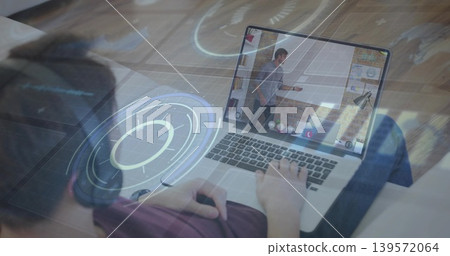 Using laptop on sofa teen wearing over-ear headset viewing host gesturing on screen holograms Using laptop on sofa teen wearing over-ear headset viewing host gesturing on screen holograms 139572064