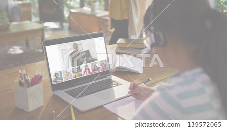 Taking notes girl wearing headset, striped top, at home study with laptop and notebook, copy space 139572065