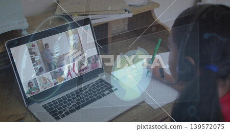 Writing kid at home wearing headphones using laptop HUD-overlay, green pencil and paper, copy space Writing kid at home wearing headphones using laptop HUD-overlay, green pencil and paper, copy space 139572075