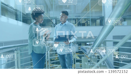 Reviewing man wearing shirt and woman in blouse sharing laptop and phone on mezzanine, AR overlays Reviewing man wearing shirt and woman in blouse sharing laptop and phone on mezzanine, AR overlays 139572152
