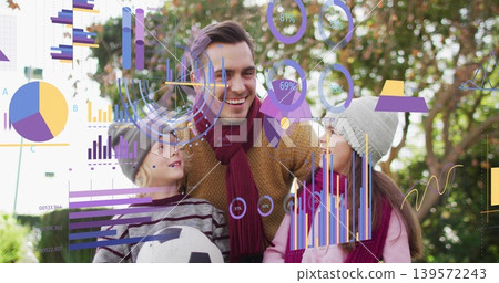 Smiling family leaning in park, maroon scarves and hats, son holding soccer ball with data overlays Smiling family leaning in park, maroon scarves and hats, son holding soccer ball with data overlays 139572243