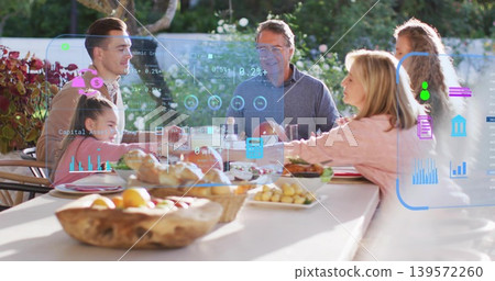 Chatting family passing dishes across backyard dining table, wooden fruit bowl and AR overlays Chatting family passing dishes across backyard dining table, wooden fruit bowl and AR overlays 139572260