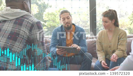 Tapping bearded man in blue shirt over orange tee holding tablet in lounge, with cyan charts Tapping bearded man in blue shirt over orange tee holding tablet in lounge, with cyan charts 139572320