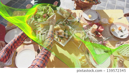 Reaching diners' hands grabbing roast and salad on yellow cloth at patio, plaid sleeve Reaching diners' hands grabbing roast and salad on yellow cloth at patio, plaid sleeve 139572345